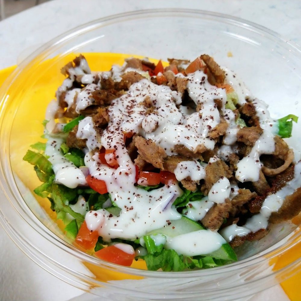 Shawarma bowl with garlic sauce and fresh salad